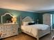 Main bedroom with a large bed and white dresser at 36750 Us Highway 19 N # 21-302, Palm Harbor, FL 34684