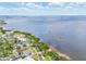 Scenic aerial view showcasing coastal neighborhood, open bay waters, and lush green landscapes at 131 Pennsylvania Ave, Palm Harbor, FL 34683