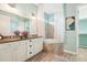 Bathroom featuring double vanity sinks and large soaking tub at 131 Pennsylvania Ave, Palm Harbor, FL 34683