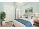 Cozy bedroom with closet, ceiling fan, neutral paint, and a picture window at 131 Pennsylvania Ave, Palm Harbor, FL 34683