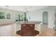 Granite kitchen island featuring drawers and storage with view to the living room at 131 Pennsylvania Ave, Palm Harbor, FL 34683