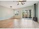 Bright living room features a ceiling fan, fireplace and sliding glass doors to the outside patio at 131 Pennsylvania Ave, Palm Harbor, FL 34683