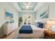 Large main bedroom features a tray ceiling, french doors to the outside and coastal decor at 131 Pennsylvania Ave, Palm Harbor, FL 34683