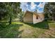 Tan house exterior with green lawn and mature trees at 3482 Rolling Trl, Palm Harbor, FL 34684