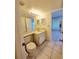 Neutral bathroom with ceramic tile, vanity, and fixtures and view into the hall at 6802 Stones Throw N Cir # 14206, St Petersburg, FL 33710