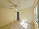 Simple bedroom features a ceiling fan, neutral paint and tile flooring at 6802 Stones Throw N Cir # 14206, St Petersburg, FL 33710