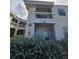 Inviting two-story condo with a private balcony overlooking the manicured front yard and lush landscaping at 6802 Stones Throw N Cir # 14206, St Petersburg, FL 33710