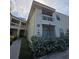 Charming condo with a balcony, featuring neat landscaping and a sidewalk leading to the building entrance at 6802 Stones Throw N Cir # 14206, St Petersburg, FL 33710