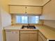 Bright kitchen features a stainless steel sink, plenty of counter space, and a dishwasher for easy clean-up at 6802 Stones Throw N Cir # 14206, St Petersburg, FL 33710