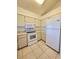 Practical kitchen offers white appliances, ample storage, and a clean design for a convenient cooking experience at 6802 Stones Throw N Cir # 14206, St Petersburg, FL 33710