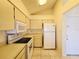 Efficient kitchen features white appliances, tiled floor, and ample cabinet space for a clean, modern look at 6802 Stones Throw N Cir # 14206, St Petersburg, FL 33710