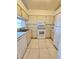 Functional kitchen featuring white appliances, tile flooring, and a bright atmosphere for pleasant cooking at 6802 Stones Throw N Cir # 14206, St Petersburg, FL 33710