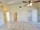 Spacious living room featuring tiled floors, a fan, and doorways leading to other rooms for seamless living at 6802 Stones Throw N Cir # 14206, St Petersburg, FL 33710
