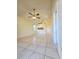 Bright living room with tiled floors, a ceiling fan, and a view to the kitchen for easy entertaining at 6802 Stones Throw N Cir # 14206, St Petersburg, FL 33710