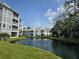 Water view of the community pond with fountain surrounded by lush landscaping at 6802 Stones Throw N Cir # 14206, St Petersburg, FL 33710