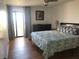 Bedroom with king-size bed, wood-look floors, and access to balcony at 830 S Gulfview Blvd # 601, Clearwater Beach, FL 33767