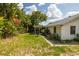 Backyard view, showing home and patio at 4936 Mineola Pl, Palm Harbor, FL 34684