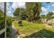 Large backyard with grassy area and grill at 4936 Mineola Pl, Palm Harbor, FL 34684