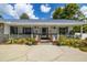 Inviting front porch with white railing and colorful potted plants at 4936 Mineola Pl, Palm Harbor, FL 34684