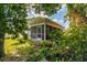 Screened porch surrounded by lush greenery at 4936 Mineola Pl, Palm Harbor, FL 34684
