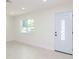 Bright and airy living room with tile floors and new door at 9197 79Th Ave, Seminole, FL 33777