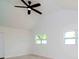 Bright bedroom with ceiling fan, wood-look floors, and two windows at 9197 79Th Ave, Seminole, FL 33777