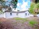 Rear view of house showcasing white exterior and landscaping at 9197 79Th Ave, Seminole, FL 33777