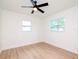 Well-lit bedroom featuring hardwood floors, ceiling fan, and multiple windows at 9197 79Th Ave, Seminole, FL 33777