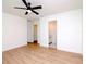 Bedroom with ceiling fan, wood-look floors and access to bathroom and closet at 9197 79Th Ave, Seminole, FL 33777