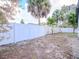 Backyard with white vinyl fence and mature trees at 9197 79Th Ave, Seminole, FL 33777
