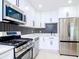 Modern kitchen with stainless steel appliances and a herringbone backsplash at 9197 79Th Ave, Seminole, FL 33777