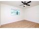 Bright bedroom with ceiling fan, light wood flooring, and two windows at 9197 79Th Ave, Seminole, FL 33777