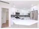 Modern kitchen with white cabinets, quartz countertops, and stainless steel appliances at 9197 79Th Ave, Seminole, FL 33777