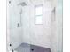 Modern bathroom with walk-in shower and marble tile at 9197 79Th Ave, Seminole, FL 33777