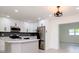 Modern kitchen with white cabinets, stainless steel appliances, and quartz countertops at 9197 79Th Ave, Seminole, FL 33777