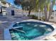 Community hot tub with seating area and nearby lounge chairs at 6802 Stones Throw N Cir # 14206, St Petersburg, FL 33710