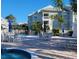 Inviting pool and spa area with lounge chairs and patio tables at 6802 Stones Throw N Cir # 14206, St Petersburg, FL 33710