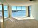Bright living room with floor-to-ceiling windows offering stunning water views at 100 Pierce St # 703, Clearwater, FL 33756