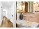 Elegant bathroom featuring pink tiles, a marble sink, and decorative lighting at 716 14Th Ne Ave, St Petersburg, FL 33701