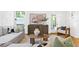 Comfortable living room featuring light grey walls, a plush sectional, and a decorative cabinet at 716 14Th Ne Ave, St Petersburg, FL 33701