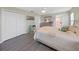 Spacious bedroom with large bed, double doors, and light wood flooring at 577 Vista Trail Ct, Palm Harbor, FL 34683