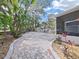 Brick pathway leading to a cozy screened porch at 577 Vista Trail Ct, Palm Harbor, FL 34683