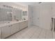 Clean bathroom with double sinks, good storage, and tile flooring at 577 Vista Trail Ct, Palm Harbor, FL 34683