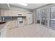 White kitchen cabinets, granite counters, and a view to backyard at 577 Vista Trail Ct, Palm Harbor, FL 34683