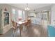Bright dining room with wood table and chairs, view into kitchen at 577 Vista Trail Ct, Palm Harbor, FL 34683