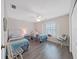 Cozy bedroom with twin beds, window seat, and ceiling fan at 577 Vista Trail Ct, Palm Harbor, FL 34683