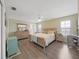 Spacious main bedroom with a king-size bed and wood floors at 577 Vista Trail Ct, Palm Harbor, FL 34683