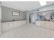 Kitchen boasts white cabinets, granite countertops, and tile flooring at 577 Vista Trail Ct, Palm Harbor, FL 34683