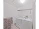 Convenient laundry room with washer, dryer, and overhead shelving at 577 Vista Trail Ct, Palm Harbor, FL 34683