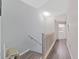 Upstairs hallway with wood flooring and access to laundry and bedrooms at 577 Vista Trail Ct, Palm Harbor, FL 34683